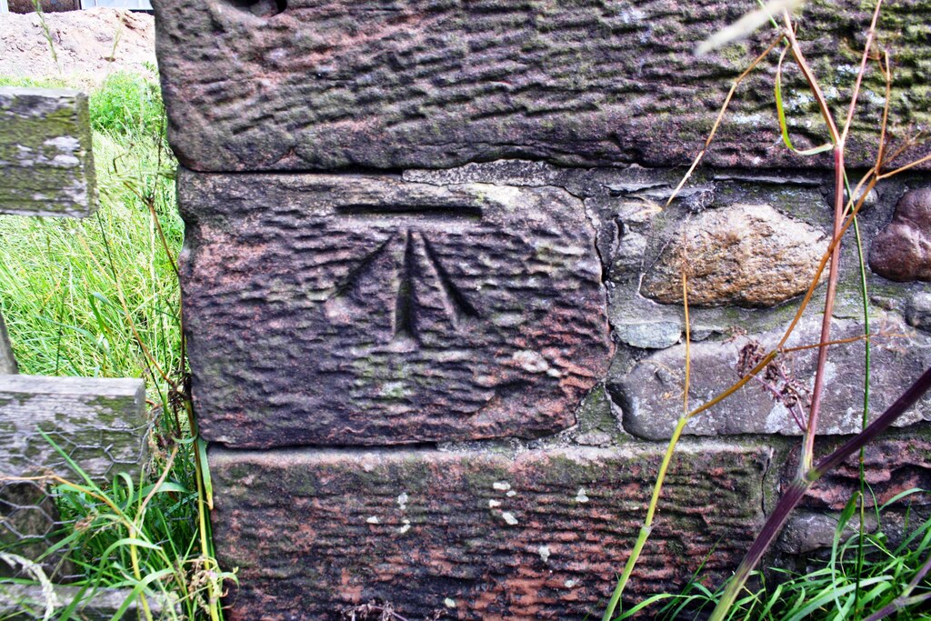 Benchmark on wall on SE side of B5300 at East End Farm